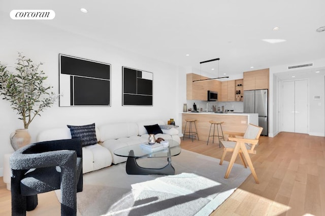 living room with light hardwood / wood-style flooring