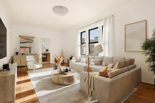 living area featuring light wood-style floors and baseboards