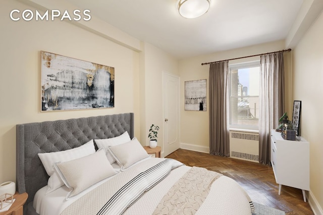 bedroom featuring radiator heating unit and baseboards