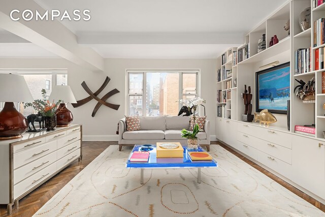 living area with plenty of natural light and baseboards