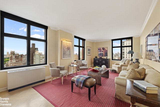 living room with crown molding, a healthy amount of sunlight, and radiator heating unit