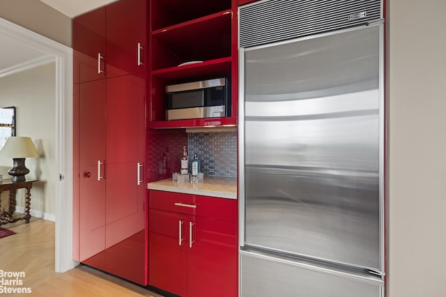 kitchen featuring backsplash, stainless steel appliances, and light parquet floors