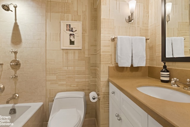 bathroom with tile walls, vanity, and toilet