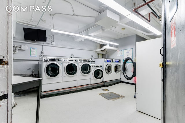 shared laundry area featuring tile patterned floors and separate washer and dryer