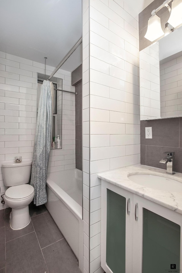 156-08 Riverside Dr W Unit 1-A, New York City, NY 10032 - full bathroom with tile walls, toilet, vanity, tile patterned flooring, and a combined bath / shower with rainfall shower