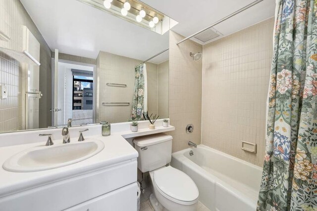 full bathroom featuring vanity, toilet, and shower / bath combo with shower curtain