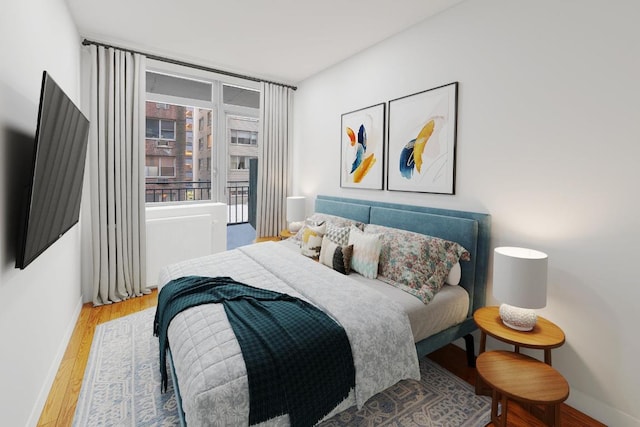 bedroom with hardwood / wood-style flooring