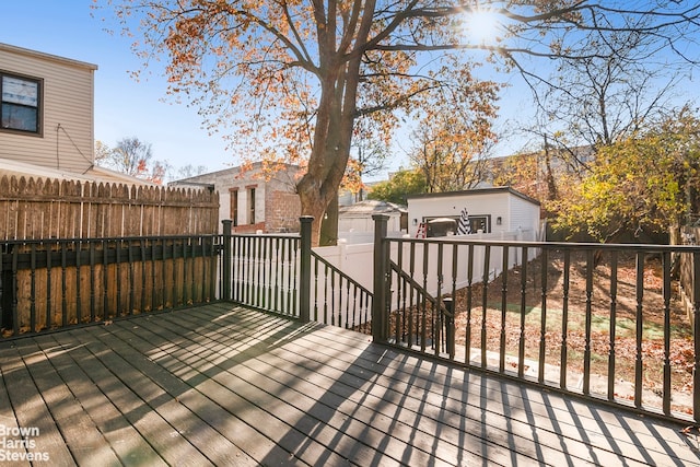 wooden deck with a garage and an outdoor structure