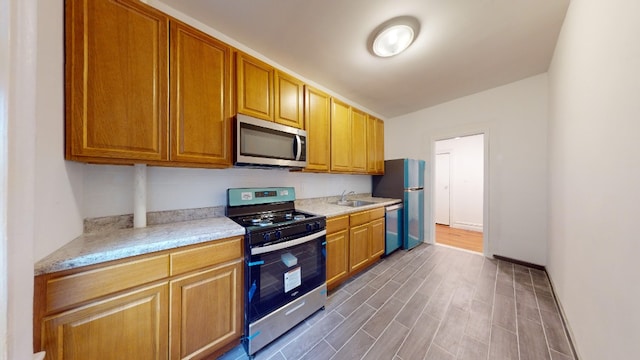 7101 Colonial Rd Unit R3H, New York City, NY 11209 - kitchen with appliances with stainless steel finishes, wood finished floors, baseboards, and a sink