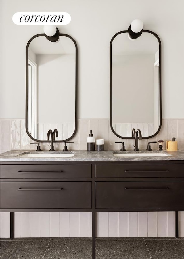 bathroom featuring a sink and double vanity