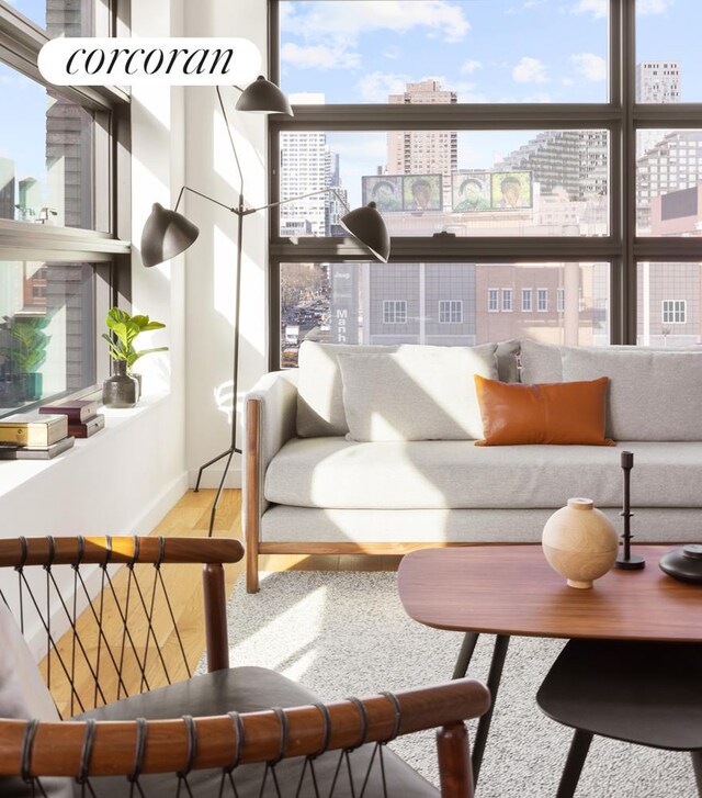 living room with a city view and wood finished floors