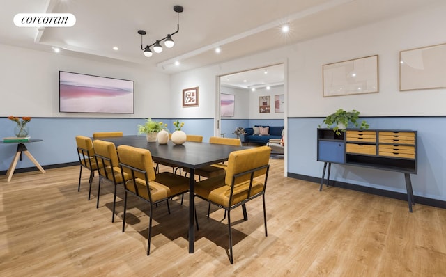 dining room with visible vents, baseboards, and light wood finished floors