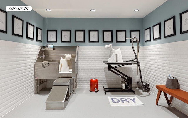 interior space featuring recessed lighting, visible vents, brick wall, and wainscoting