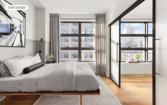 bedroom featuring light wood-style flooring and multiple windows