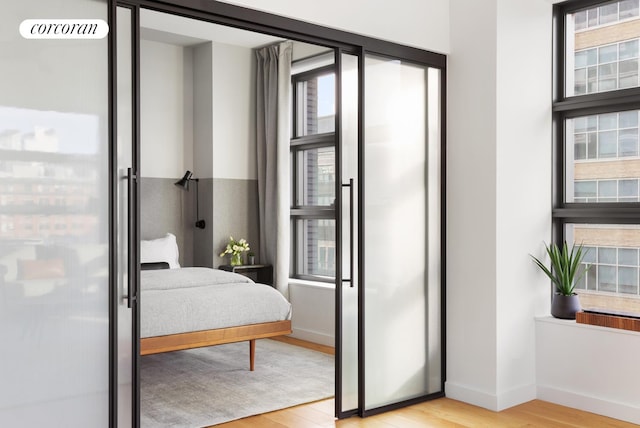 bedroom featuring baseboards and wood finished floors