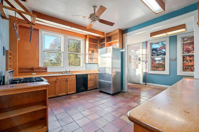 kitchen featuring ceiling fan, light tile patterned floors, sink, and black appliances