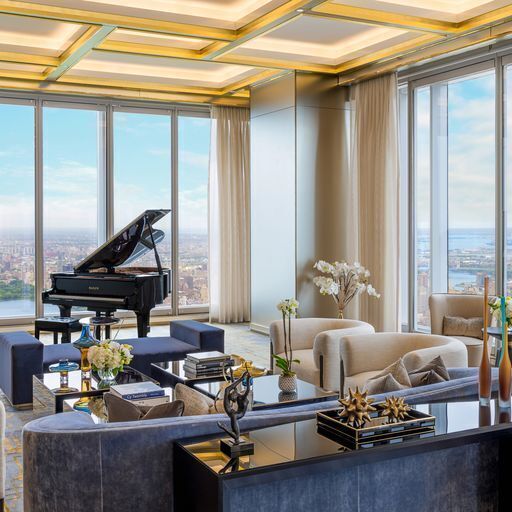 miscellaneous room featuring a wall of windows, a water view, and coffered ceiling