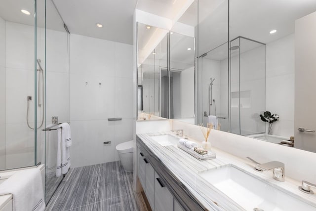 bathroom featuring toilet, tile walls, and vanity