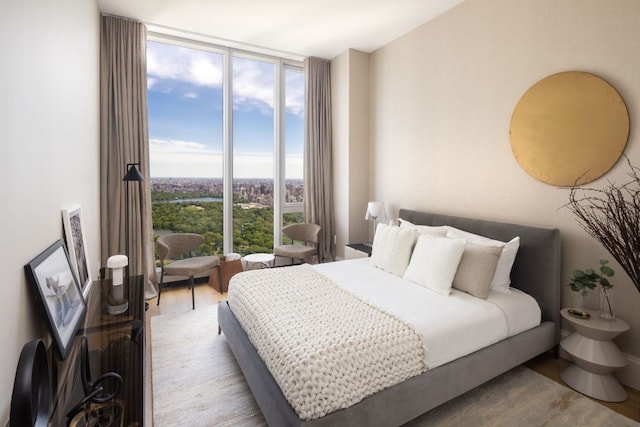 bedroom featuring light hardwood / wood-style floors and floor to ceiling windows