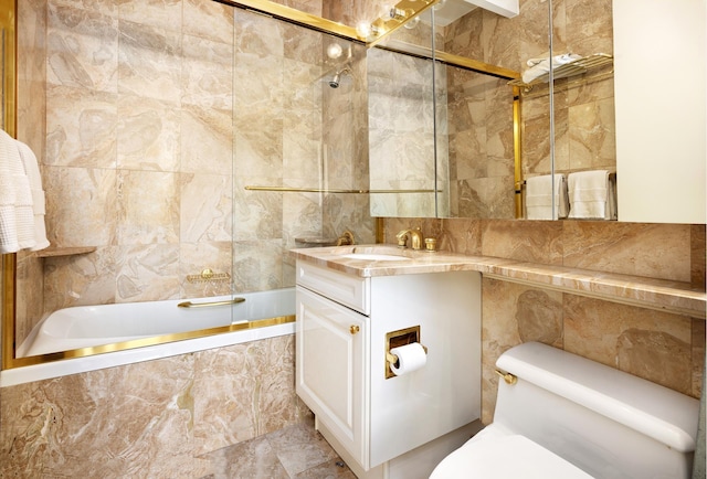 full bathroom with tiled shower / bath combo, tile walls, toilet, and vanity