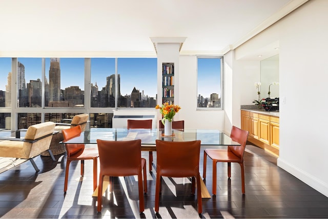 dining room with dark wood-style floors, a wall of windows, and a city view