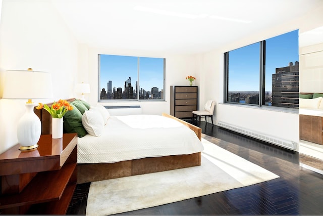 bedroom featuring a baseboard radiator and a city view