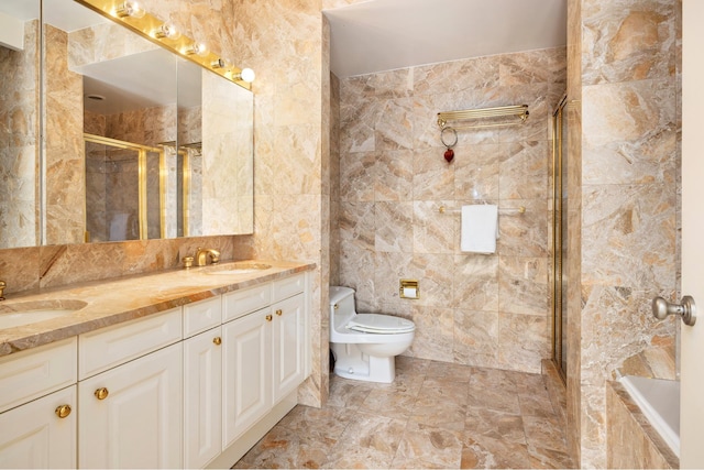 full bath featuring a stall shower, a sink, toilet, and double vanity