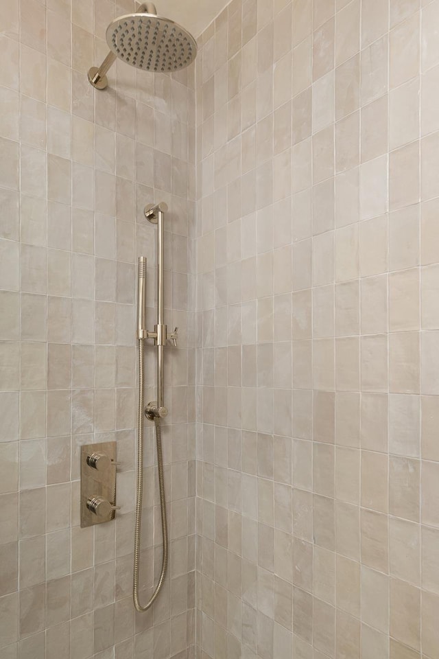 bathroom with tiled shower