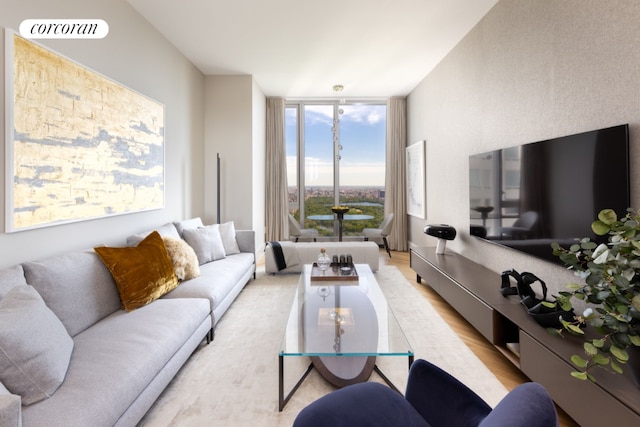 living room featuring floor to ceiling windows and light hardwood / wood-style floors