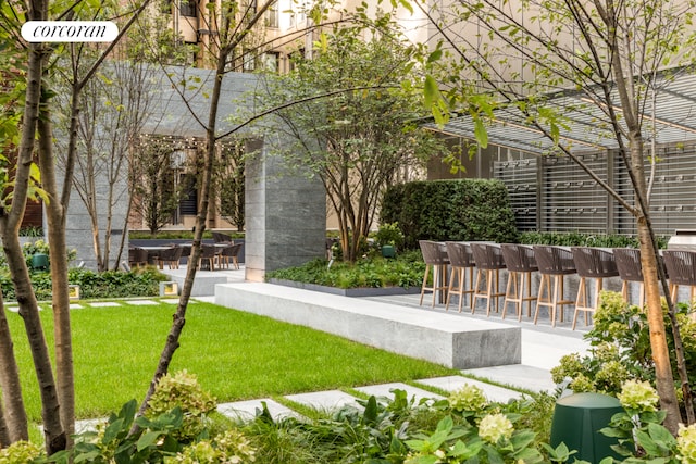 view of home's community featuring a lawn and a patio