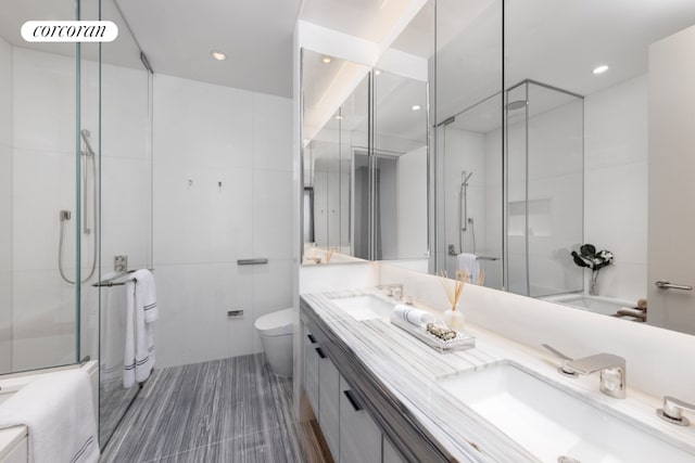 bathroom featuring vanity, toilet, and tile walls