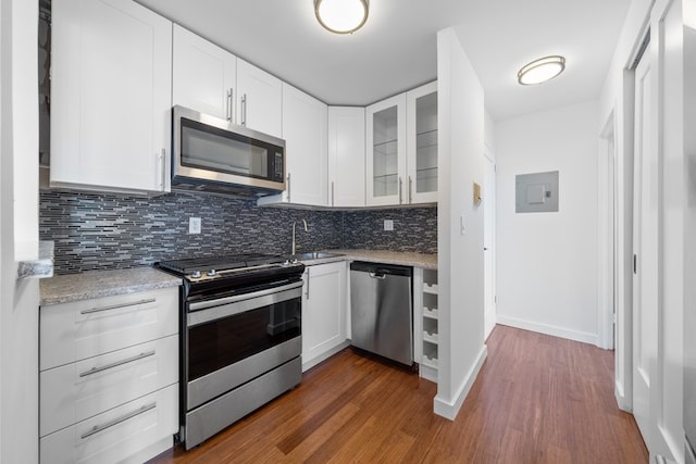 kitchen with light stone counters, sink, white cabinets, and appliances with stainless steel finishes