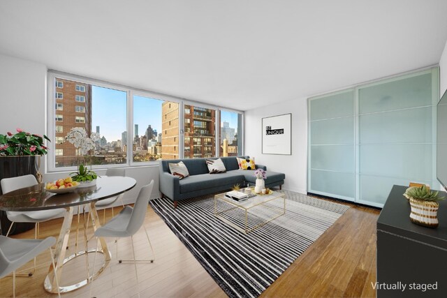 living area with wood finished floors and a city view