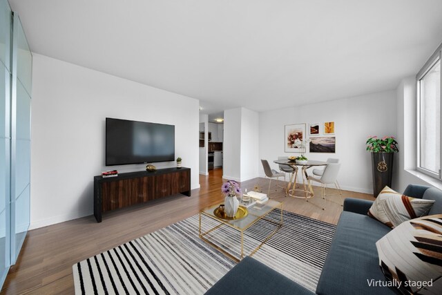 empty room featuring a wall mounted air conditioner and dark hardwood / wood-style flooring