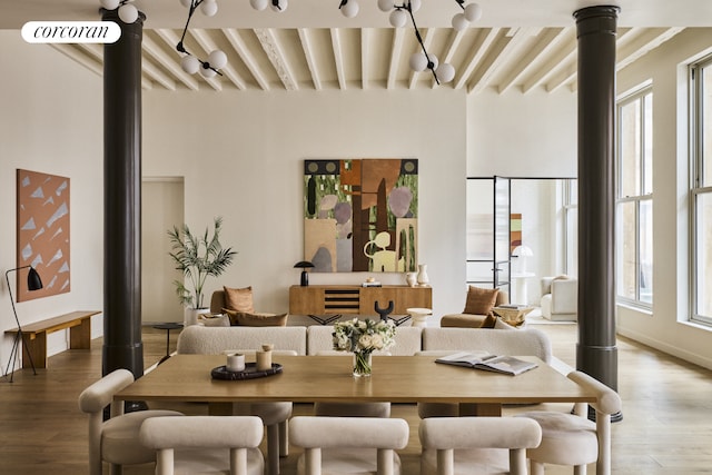 dining space with beam ceiling and light wood-type flooring