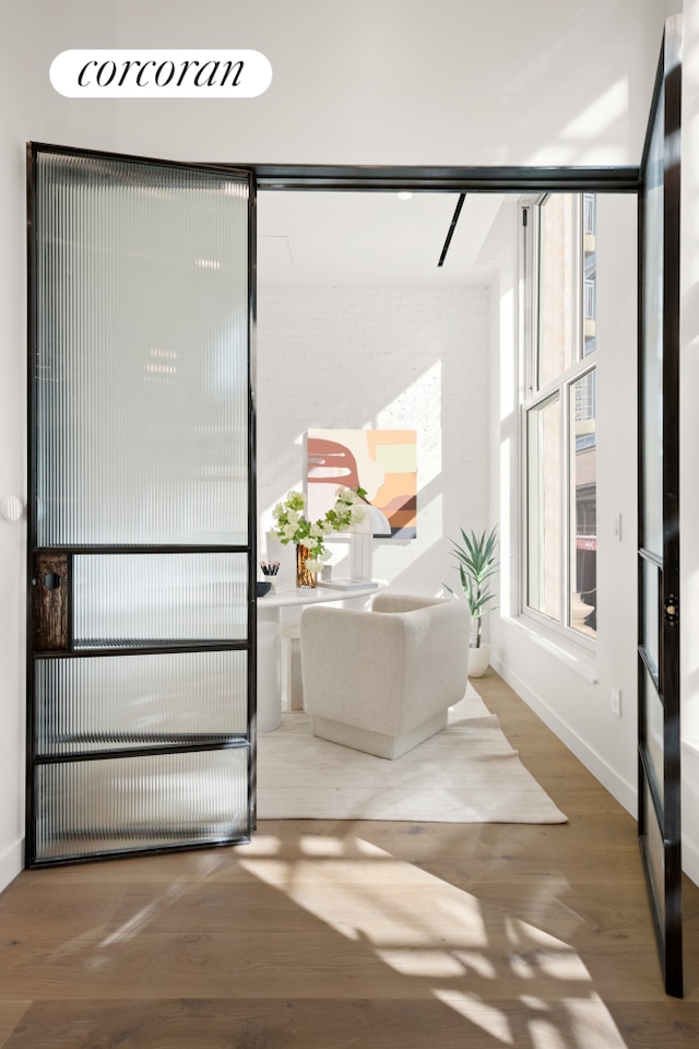 interior space featuring wood finished floors and baseboards