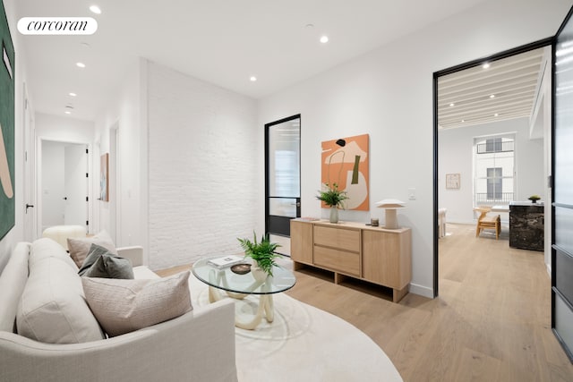 living area with light wood finished floors and recessed lighting