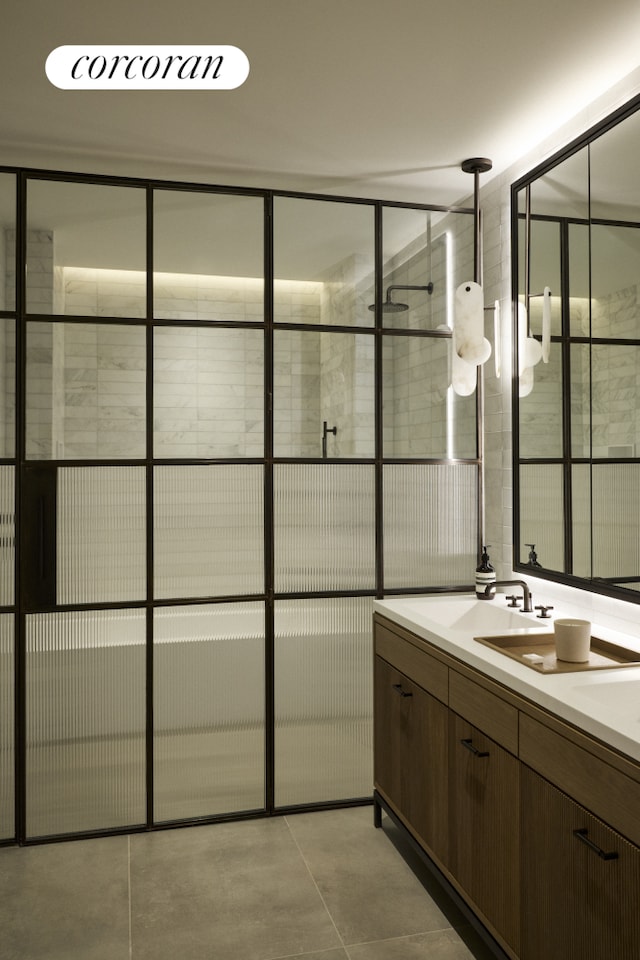 bathroom featuring a tile shower and vanity