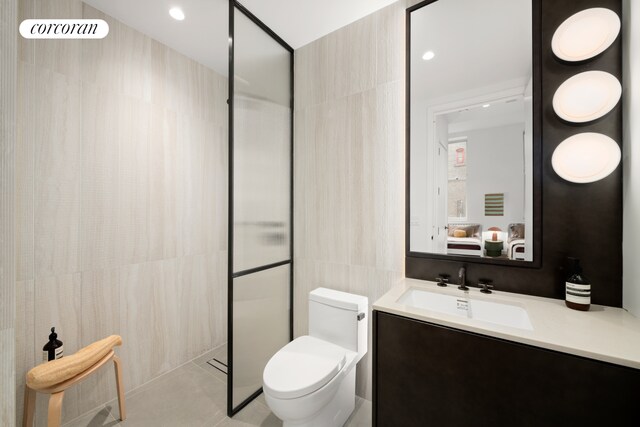 full bathroom with walk in shower, toilet, tile walls, and vanity