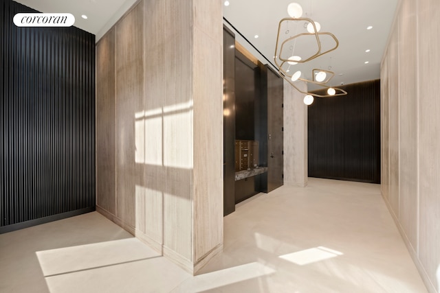 hallway with a chandelier