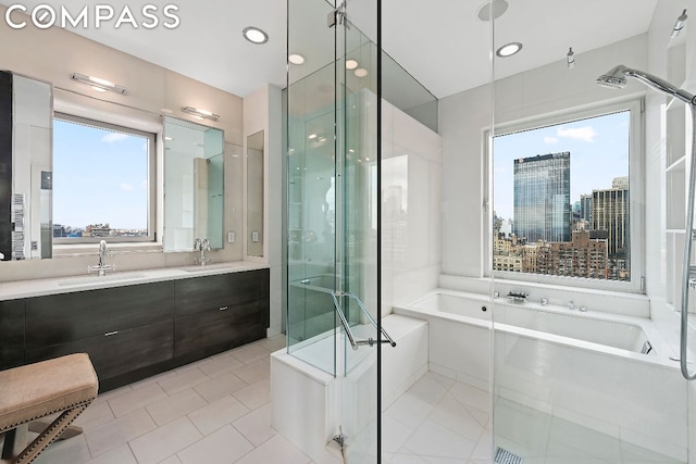 bathroom featuring a wealth of natural light, tile patterned floors, vanity, and independent shower and bath