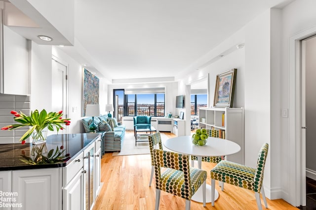 55 E End Ave Unit 16B, New York City, NY 10028 - dining room with light wood-type flooring and wine cooler