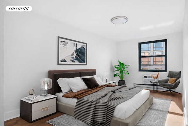 bedroom featuring dark wood-type flooring and a wall mounted AC