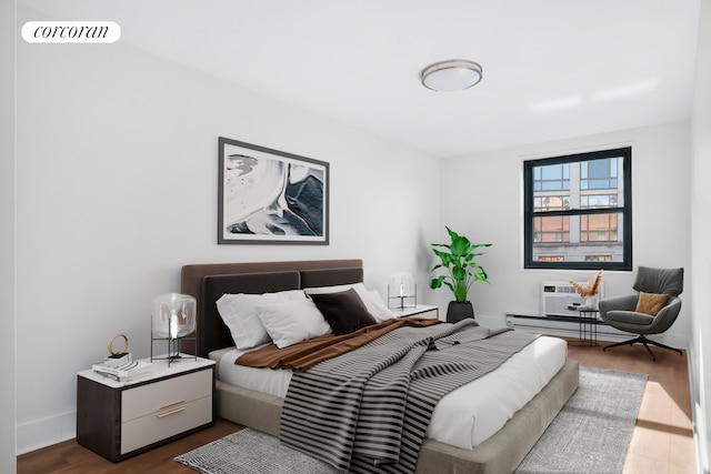 bedroom featuring dark wood-style flooring, a wall mounted air conditioner, visible vents, and baseboards