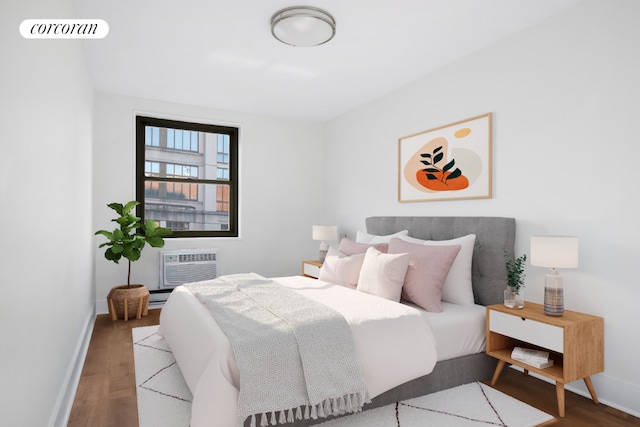 bedroom featuring a wall mounted air conditioner and hardwood / wood-style floors