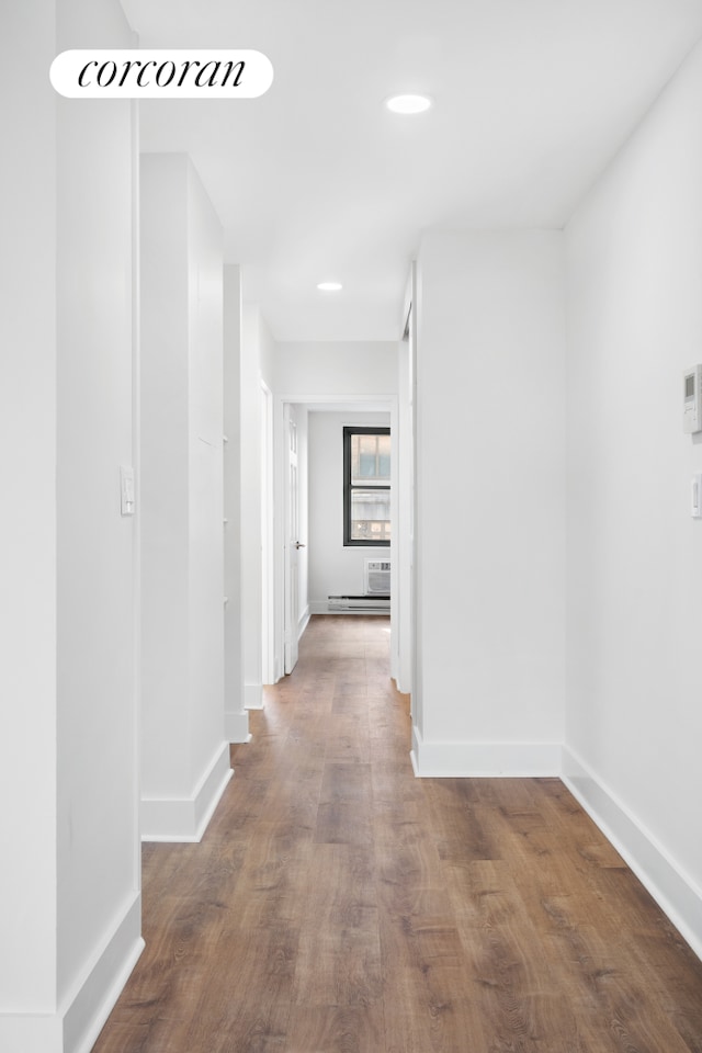 hall featuring recessed lighting, baseboards, and wood finished floors