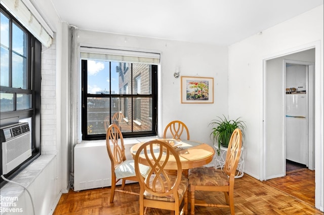 dining space with parquet floors