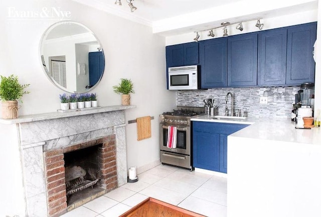 kitchen featuring backsplash, sink, blue cabinets, and stainless steel gas range