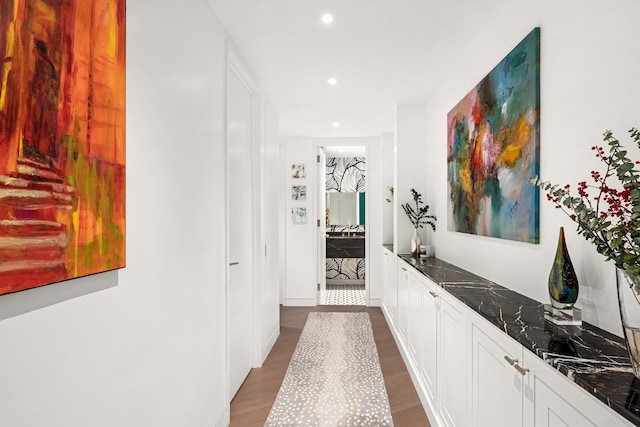 hallway featuring recessed lighting and dark wood finished floors
