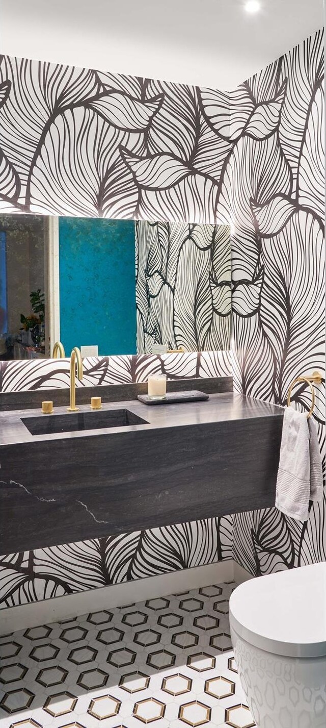 146 W 57th St Unit 42De, New York City, NY 10019 - half bath featuring a sink and toilet